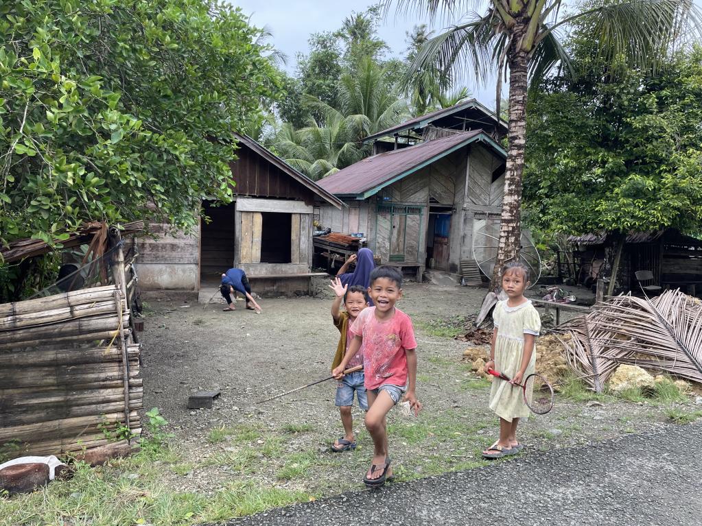 Children playing outside of their houses in Simeulue