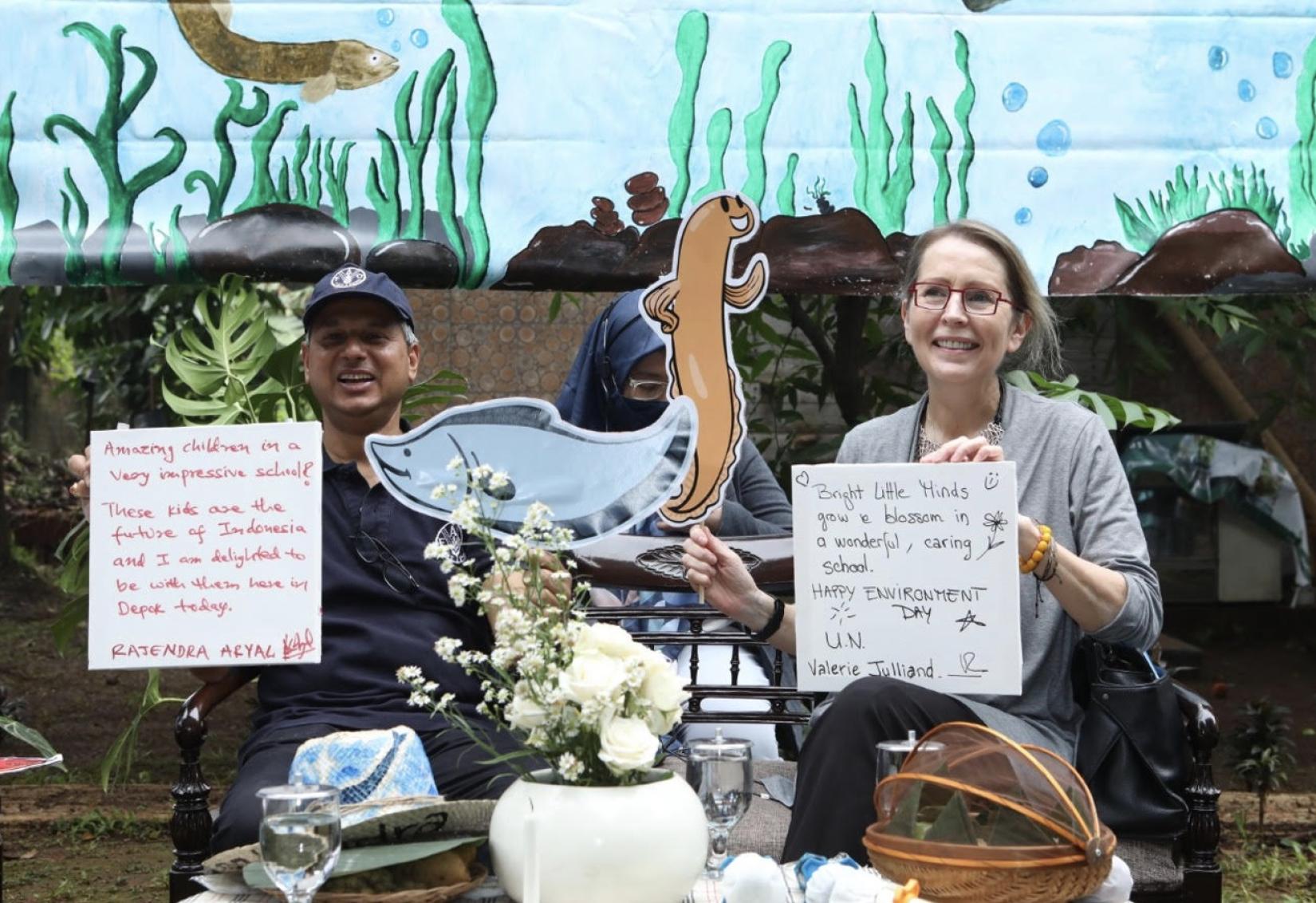 UN Resident Coordinator in Indonesia Valerie Julliand and FAO Representative Rajendra Ayal hold up plaques commemorating their visit to Sekolah Alam Matoa, West Java on June 16, 2022