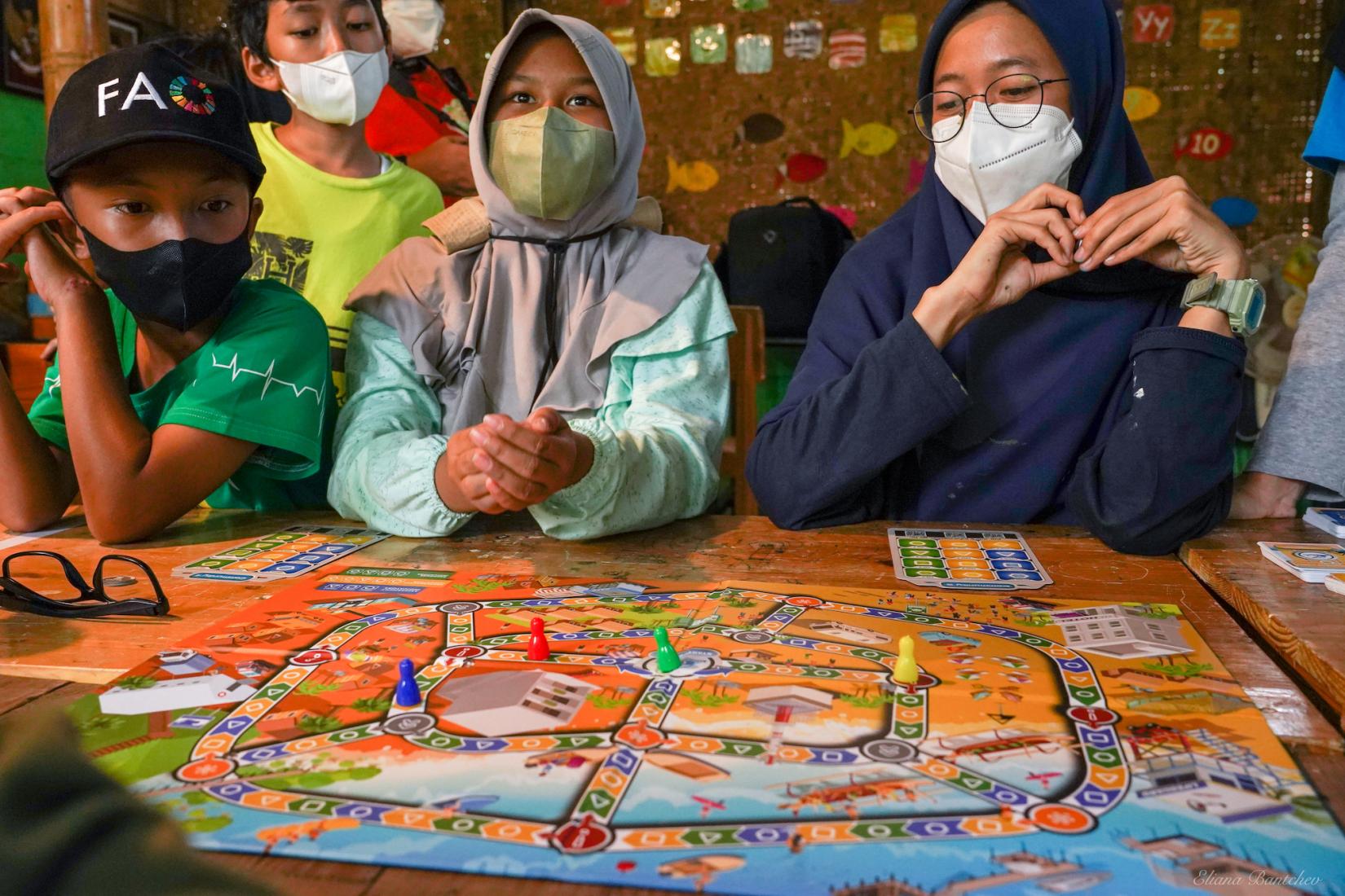 Students play a UNESCO board game designed to promote tsunami readiness and disaster resilience at Sekolah Alam Matoa in West Java, Indonesia, on June 16, 2022