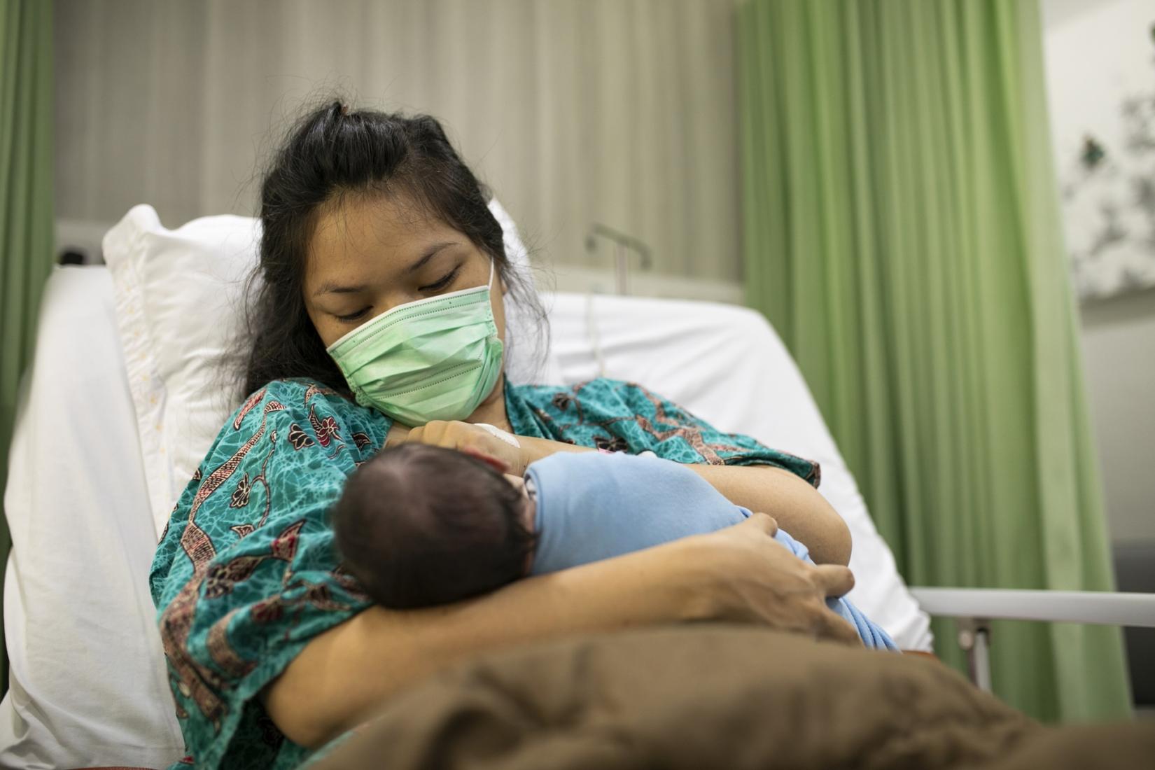 Mother feeding her newborn baby in the hospital