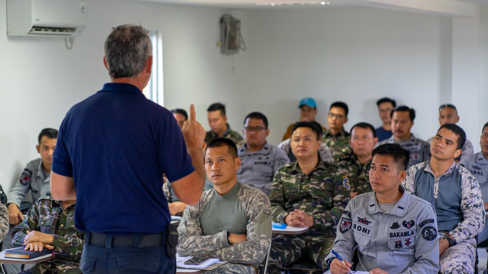 Officers from Indonesia’s Coast Guard (BAKAMLA), Malaysia’s Maritime Enforcement Agency (MMEA), and Viet Nam’s Customs Office take part in an exercise at the Visit, Board, Search, and Seizure training facility in Batam, Indonesia, on June 15, 2023