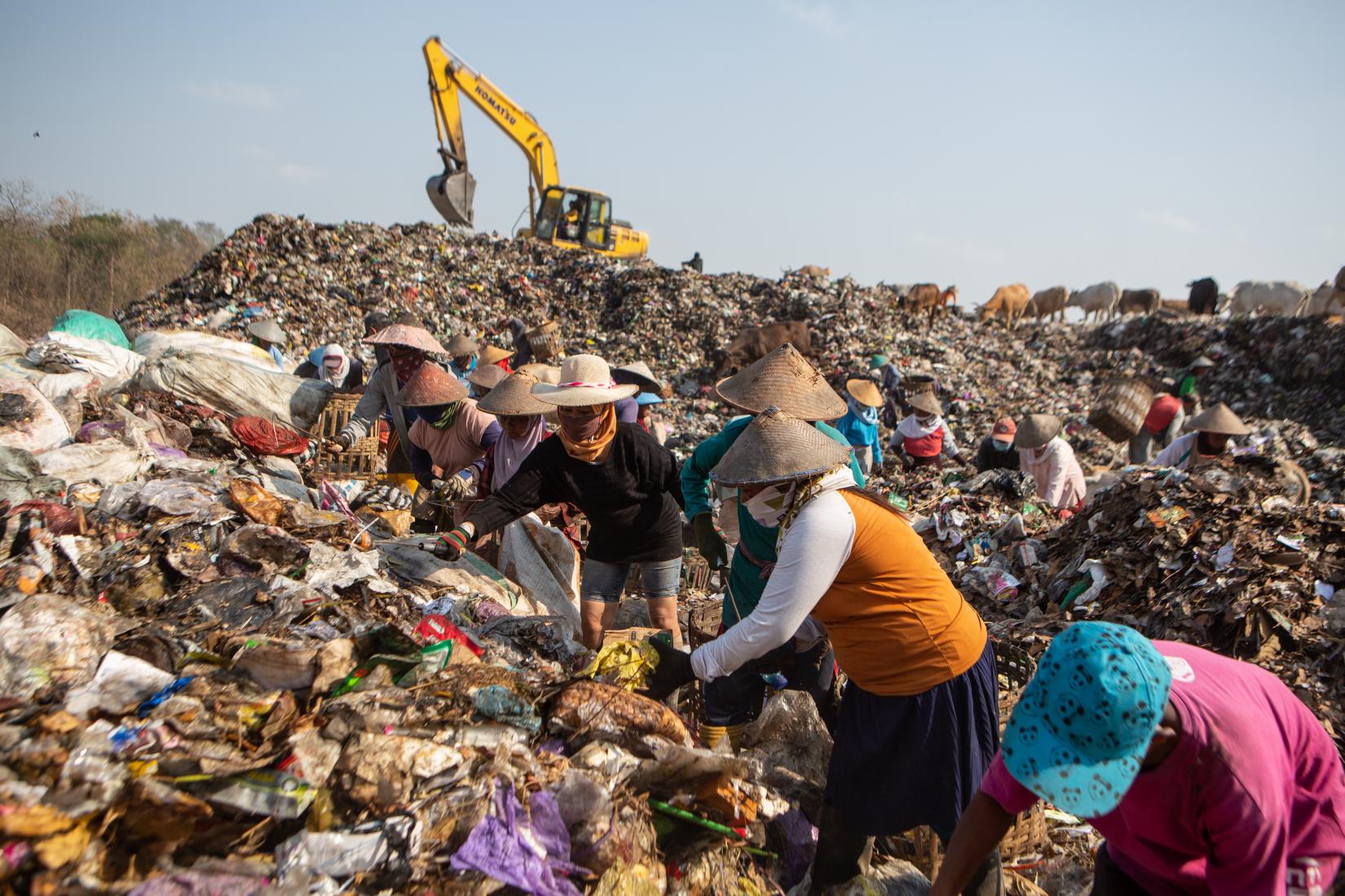 Dozens of workers at Piyungan landfill sorting waste