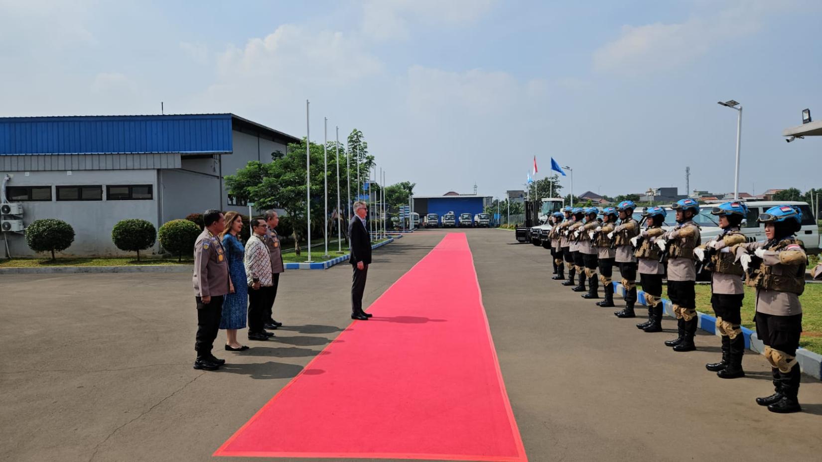 A row of peacekeepers from Indonesia stand befor Lacroix, Sabharwal, adn high police officials