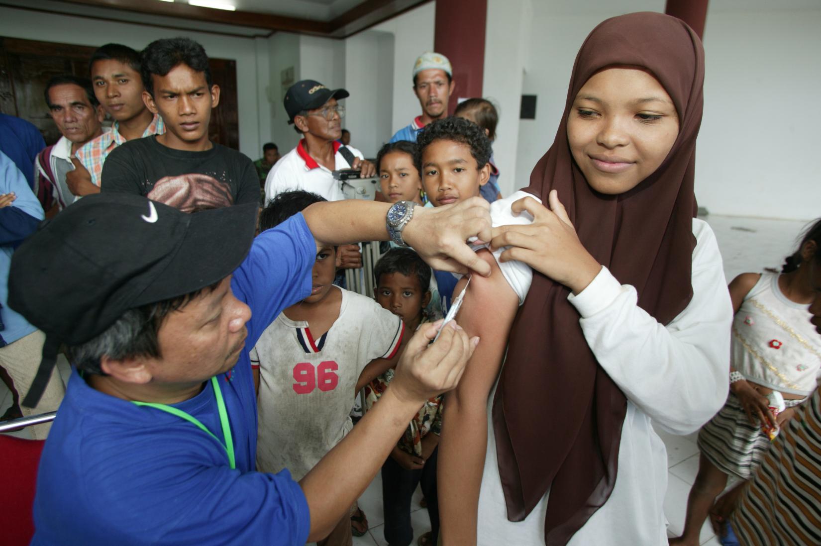 Fatia, 15, is vaccinated against measles at a camp for people displaced by the Tsunami in Banda Aceh, the capital of the province of Aceh on Sumatra Island. Many of the doctors participating in the UNICEF-supported measles campaign were volunteers from other provinces in the country.