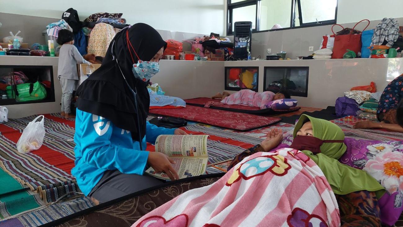 Restu Nur Intan Pratiwi, a midwife based in Jember, East Java, volunteered to support disaster recovery following the 2021 Mount Semeru eruption.